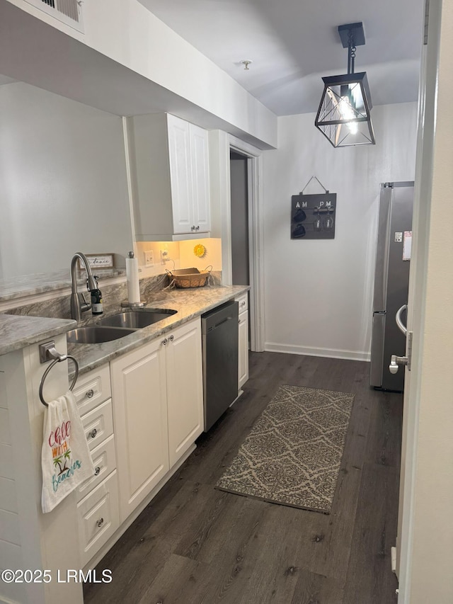 80 Paddle Boat Ln Unit 806, Hilton Head Island, SC 29928 - kitchen featuring stainless steel appliances, white cabinetry, dark wood-type flooring, and light stone countertops