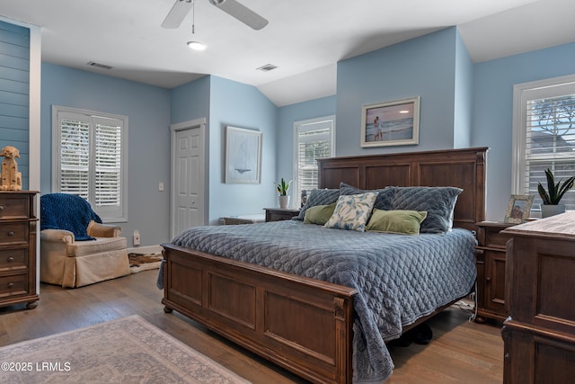 bedroom with visible vents and multiple windows