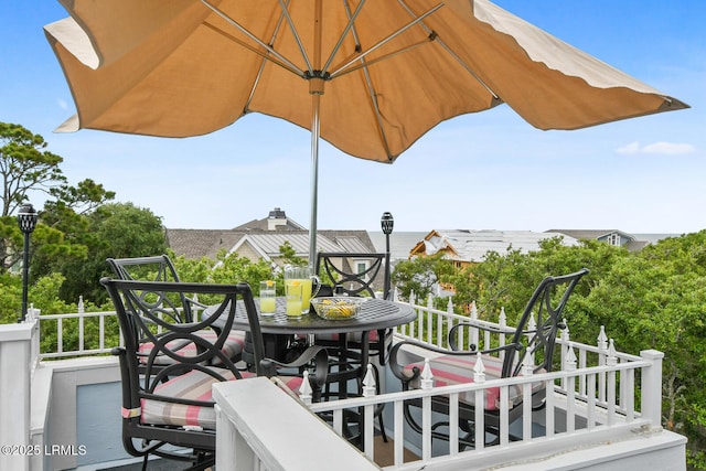 wooden deck featuring outdoor dining area