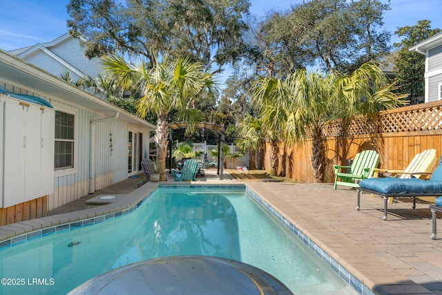 view of swimming pool featuring a fenced backyard, a fenced in pool, and a patio