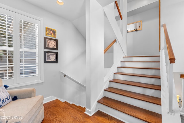 staircase with recessed lighting, wood finished floors, and baseboards