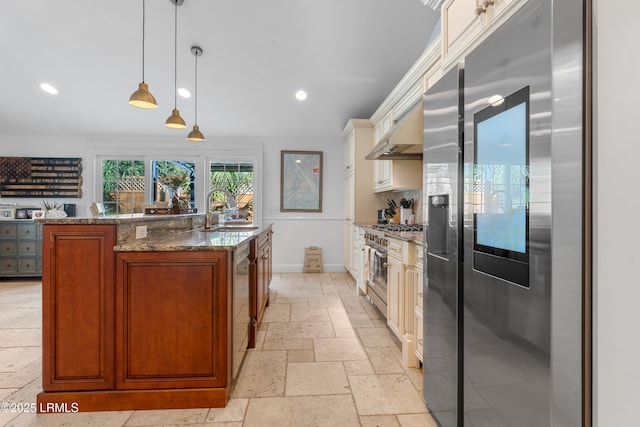 kitchen with stone tile floors, stainless steel appliances, under cabinet range hood, a sink, and recessed lighting