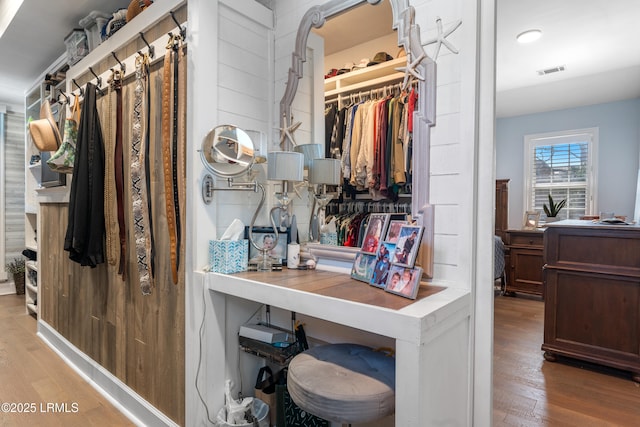 walk in closet with wood finished floors and visible vents