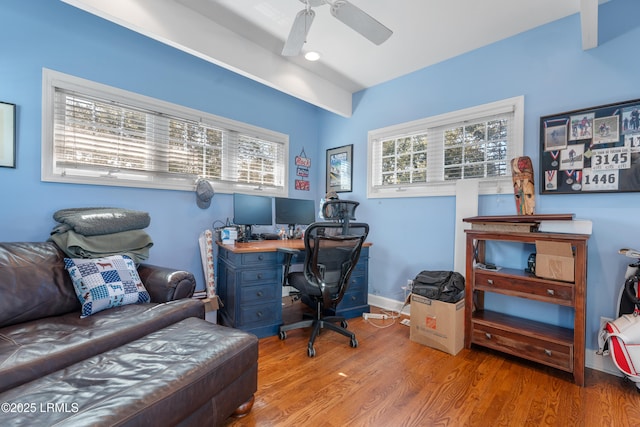 office space featuring ceiling fan, plenty of natural light, baseboards, and wood finished floors