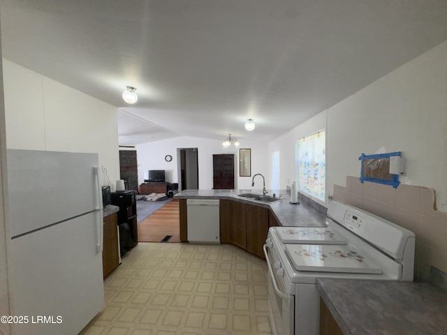 36 Clear Spring Rd, Saint Helena Island, SC 29920 - kitchen featuring white appliances, vaulted ceiling, light floors, open floor plan, and a peninsula