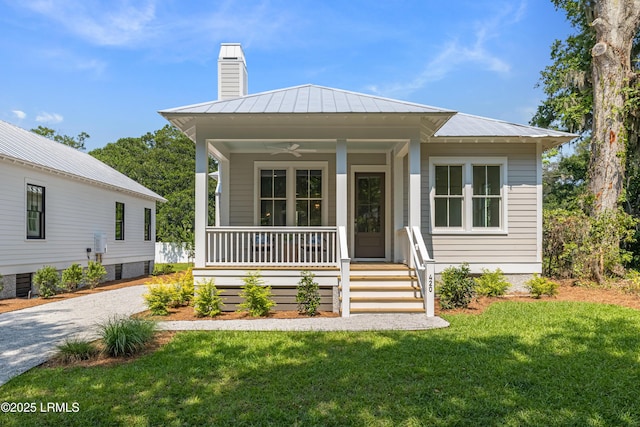 420 Waight St, Beaufort, SC 29902 - view of front of home with a porch, a chimney, a front yard, ceiling fan, and a standing seam roof