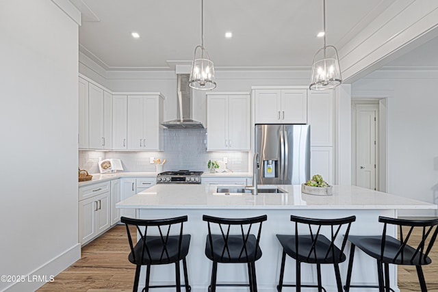 420 Waight St, Beaufort, SC 29902 - kitchen with appliances with stainless steel finishes, wall chimney exhaust hood, a chandelier, ornamental molding, and an island with sink