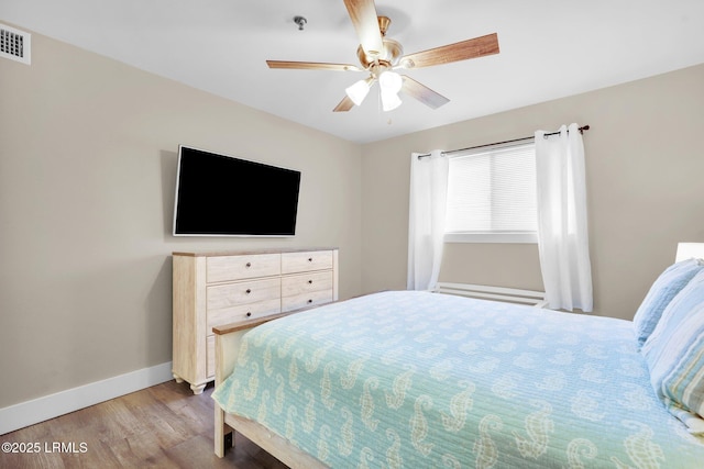 bedroom with light wood-type flooring and ceiling fan