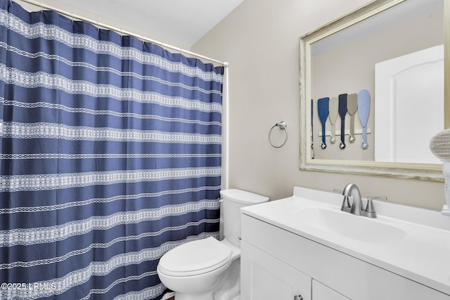 bathroom with vanity, curtained shower, and toilet