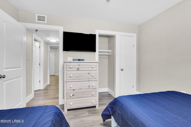 bedroom featuring hardwood / wood-style floors and a closet