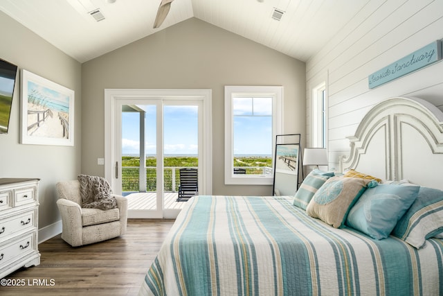 bedroom featuring access to outside, wood finished floors, lofted ceiling, and baseboards