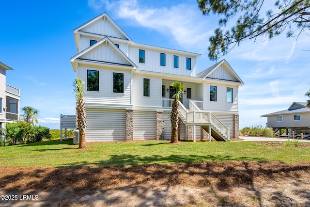 view of front of home featuring board and batten siding, stairway, covered porch, a front lawn, and stone siding