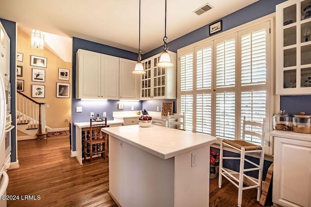 kitchen featuring white cabinetry, plenty of natural light, decorative light fixtures, and a kitchen island