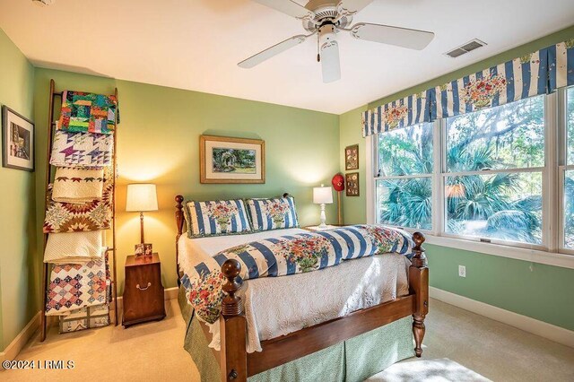 bedroom featuring ceiling fan and light colored carpet