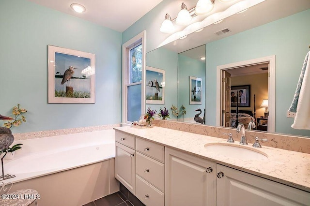 bathroom with vanity, a bathtub, and tile patterned flooring