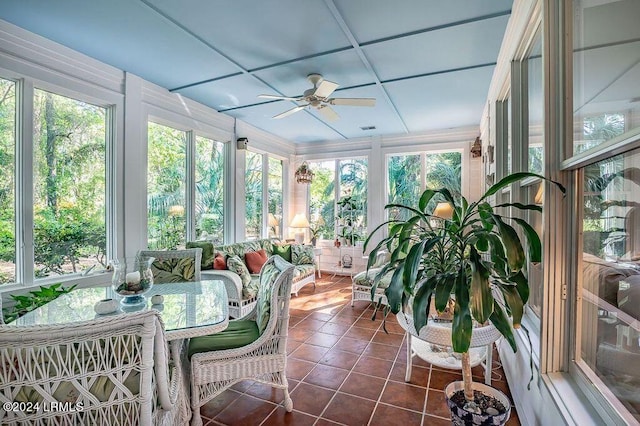 sunroom / solarium with ceiling fan and coffered ceiling