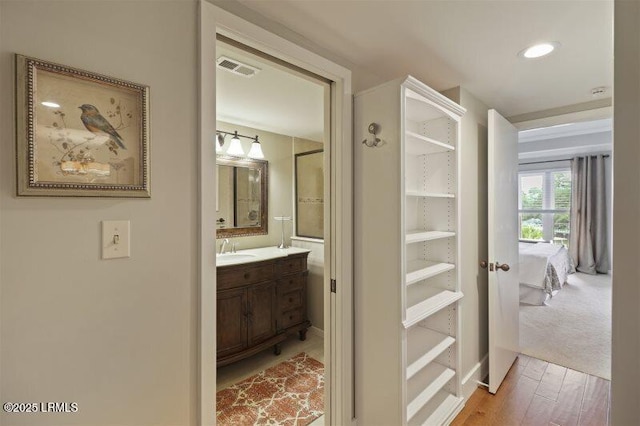 13 Harbourside Ln Unit 7155, Hilton Head Island, SC 29928 - hallway with a sink and light wood finished floors