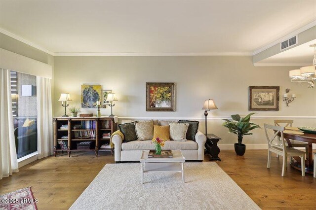 13 Harbourside Ln Unit 7155, Hilton Head Island, SC 29928 - living area with wood finished floors, a chandelier, and ornamental molding