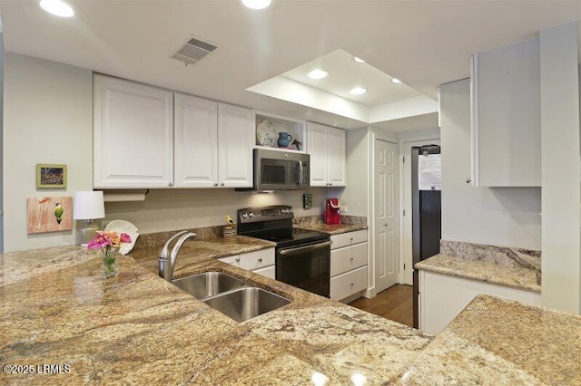 13 Harbourside Ln Unit 7155, Hilton Head Island, SC 29928 - kitchen featuring electric range oven, stainless steel microwave, recessed lighting, a raised ceiling, and white cabinetry