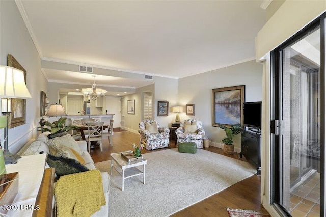 13 Harbourside Ln Unit 7155, Hilton Head Island, SC 29928 - living room featuring a chandelier, wood finished floors, and crown molding