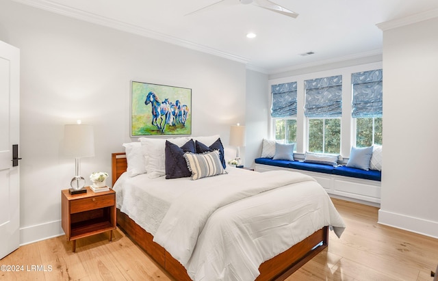 bedroom featuring ornamental molding, light wood-type flooring, and ceiling fan