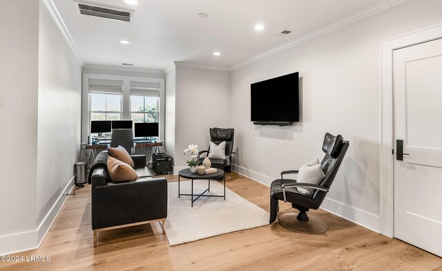 living room featuring ornamental molding and light hardwood / wood-style floors