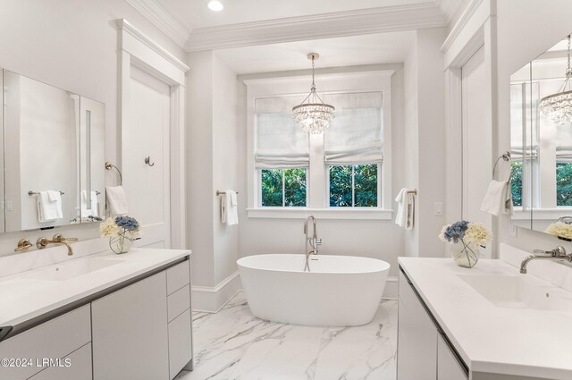 bathroom featuring vanity, ornamental molding, a notable chandelier, and a bathtub