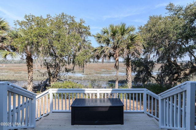 wooden deck with a rural view