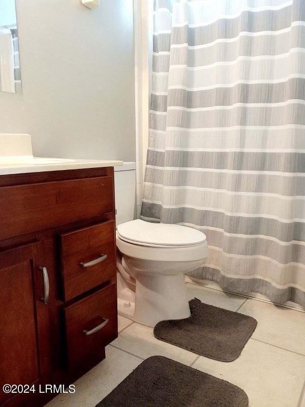 bathroom with vanity, tile patterned floors, and toilet