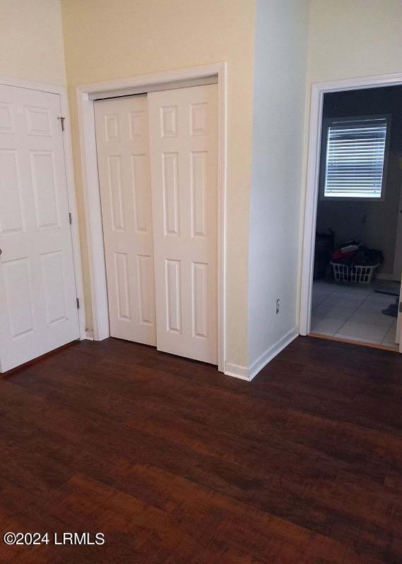 unfurnished bedroom featuring dark hardwood / wood-style flooring