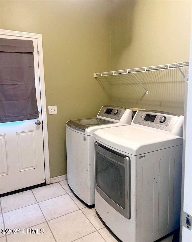 laundry room featuring light tile patterned floors and washer and dryer