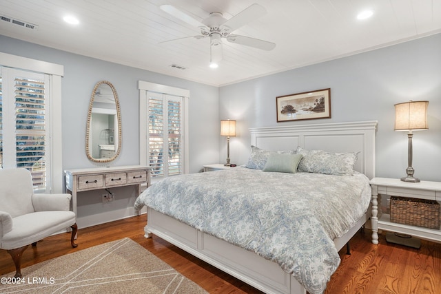 bedroom with wooden ceiling, dark hardwood / wood-style floors, and ceiling fan