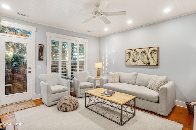 living room featuring ceiling fan, wood-type flooring, and wooden ceiling