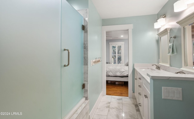 bathroom with vanity and a shower with shower door