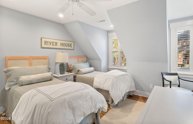 bedroom with vaulted ceiling, ceiling fan, and hardwood / wood-style floors