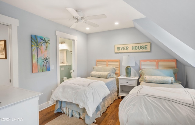 bedroom with ceiling fan, dark hardwood / wood-style floors, vaulted ceiling, and ensuite bath