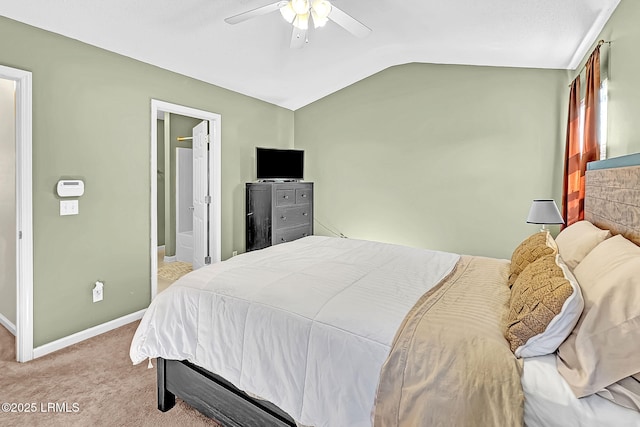 carpeted bedroom with lofted ceiling, ceiling fan, and ensuite bath