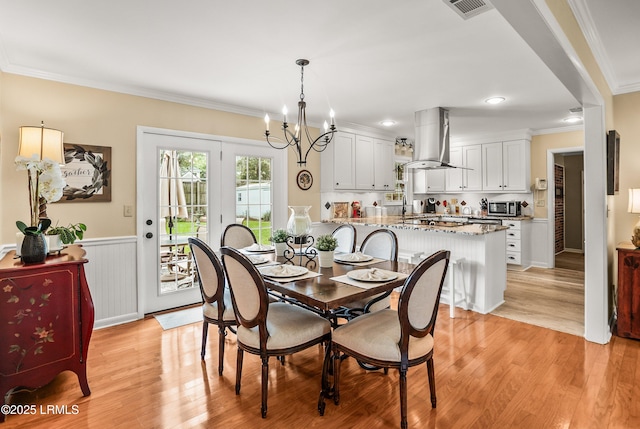 906 Belleview Cir E, Beaufort, SC 29902 - dining area with ornamental molding, light wood-style flooring, a chandelier, and wainscoting
