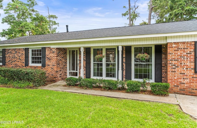 906 Belleview Cir E, Beaufort, SC 29902 - view of front of house with brick siding, a front yard, and covered porch