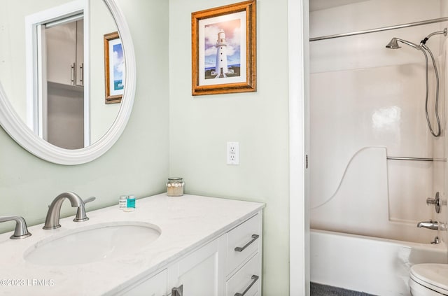 full bathroom featuring vanity, washtub / shower combination, and toilet