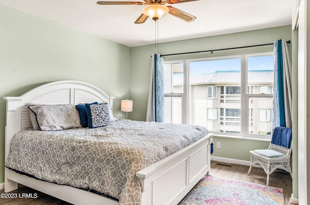 bedroom with hardwood / wood-style flooring and ceiling fan