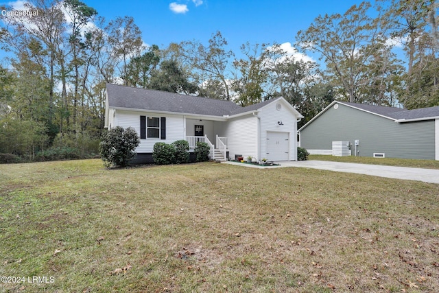 ranch-style house with a garage and a front lawn