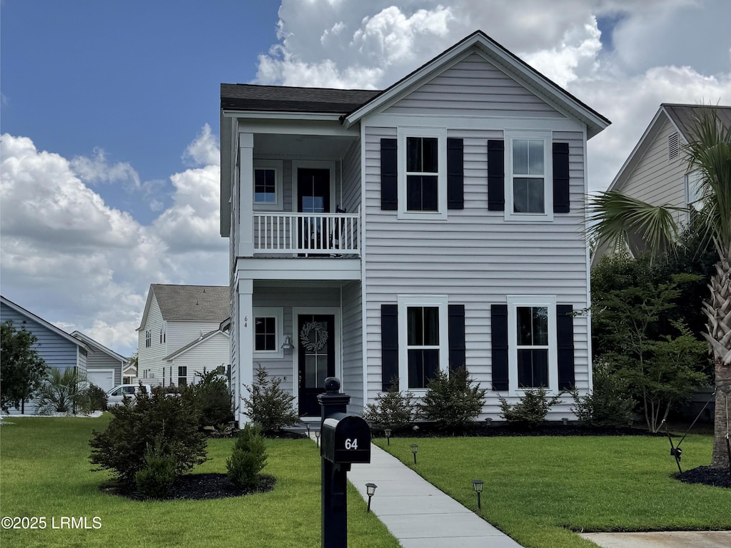 64 Hawthorn Ln, Hardeeville, SC 29927 - view of front of property featuring a balcony and a front yard