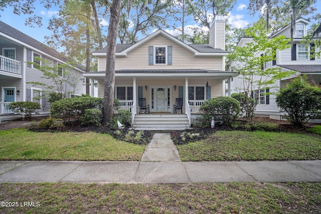 5 Regent Ave, Bluffton, SC 29910 - view of front of property with covered porch, a chimney, and a front lawn