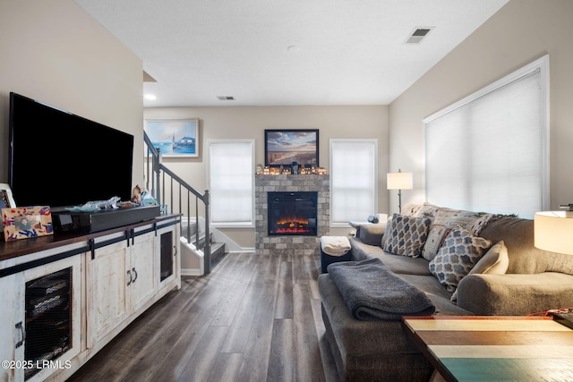 5 Regent Ave, Bluffton, SC 29910 - living area with dark wood-style flooring, a glass covered fireplace, stairs, and beverage cooler