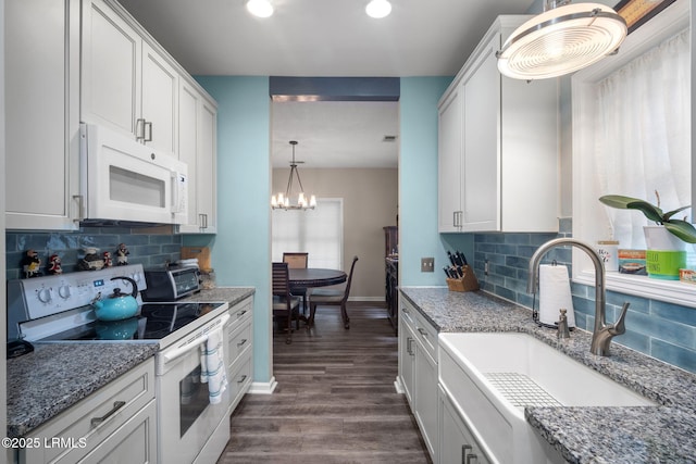 5 Regent Ave, Bluffton, SC 29910 - kitchen featuring white appliances, a chandelier, dark wood finished floors, decorative backsplash, and recessed lighting