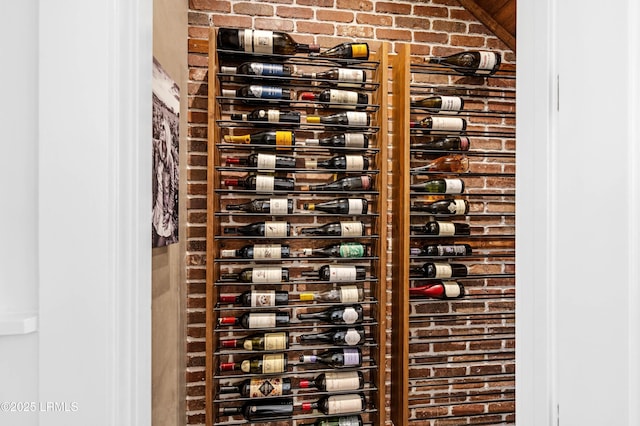 wine area with electric panel and brick wall