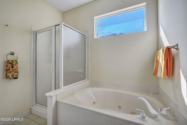 bathroom featuring a tub with jets, a stall shower, and tile patterned flooring