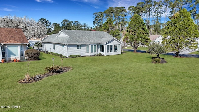 exterior space with a front lawn and roof with shingles