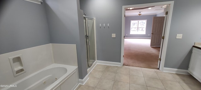 full bathroom with tile patterned floors, a shower stall, a jetted tub, and baseboards